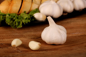 Tasty bread with Garlic. sliced garlic, garlic clove, garlic bulb, on kitchen wooden table