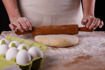 young woman wearing a duck on a wooden board in an apron