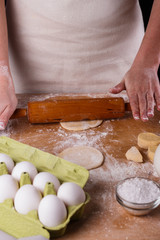 young woman wearing a duck on a wooden board in an apron