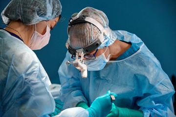 Doctor and assistant nurse operating for rescue patient from dangerous emergency case. Hospital and...