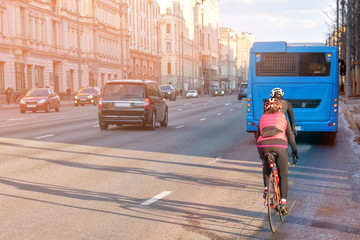 moscow city russia people travel by bike along central downtown street on early spring evening with...