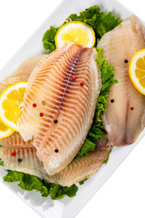 Whitefish Tilapia Fish Raw Fillet Isolated on White. Selective focus.