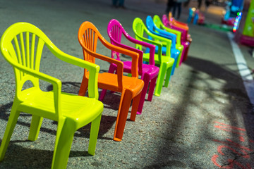Child seats of various colors in a row.