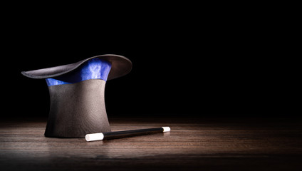 high contrast image of a magician hat on a wooden background - obrazy, fototapety, plakaty