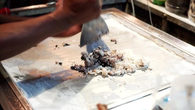 Unidentified chef is chopping delicious ice cream with oreo cookie at famous Pub street in Siem Reap, Cambodia