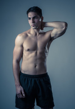 Half length portrait of strong healthy handsome Athletic man isolated on neutral background