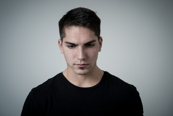 Fototapeta premium Portrait of sad and depressed young man feeling upset. Human expressions and negative emotions