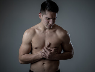 Young fit strong man suffering intense chest pain having heart attack