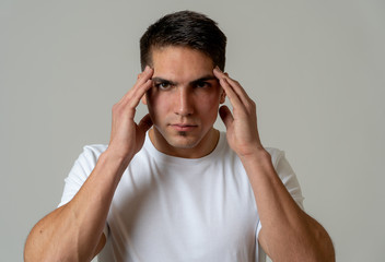 Young attractive man in pain with headache suffering migraines.