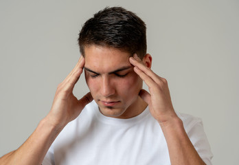 Naklejka premium Young attractive man in pain with headache suffering migraines.