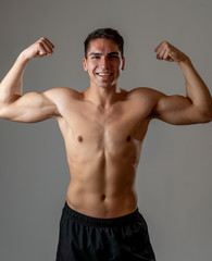 Fototapeta na wymiar Portrait of strong healthy handsome Athletic man isolated on neutral background