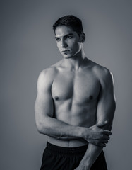 Fototapeta premium Half length portrait of strong healthy handsome Athletic man isolated on neutral background