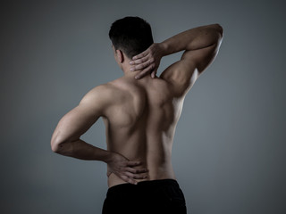 Body Pain. Strong young man suffering neck and back pain