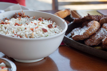 Brazilian food arroz carreteiro with picanha in a restaurant table