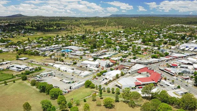 Aerial shot of the town of Beaudesert in the Scenic Rim region of Queensland Australia. Horizontal slide from left to right that takes in the whole town centre.