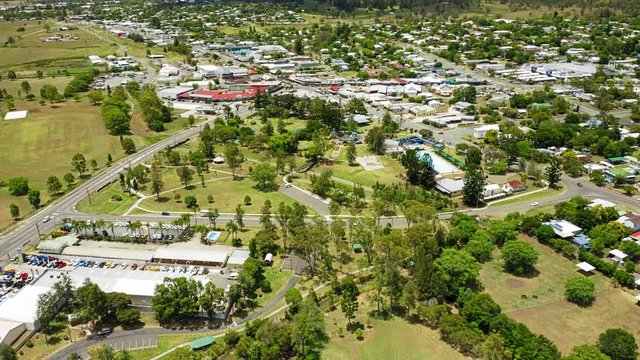 Rising aerial shot of the town of Beaudesert in the Scenic Rim region of Queensland Australia. Drone reveals entire town at midday on a stunning blue day.