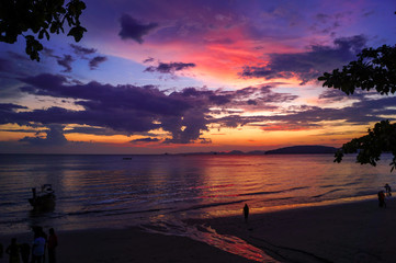 Beautiful sunset with red, purple and yellow colors at the beach in Thailand