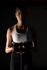 Asian slim Fitness woman exercise stretching legs arms resistance band in Fog Smoke Dark background low exposure environment, studio lighting copy space, concept Woman Can Do Sport 6 packs