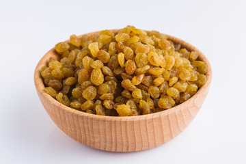 golden raisins on a white acrylic background