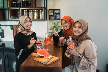 muslim woman quality time with friend having fruit cocktail for break fasting in ramadan together