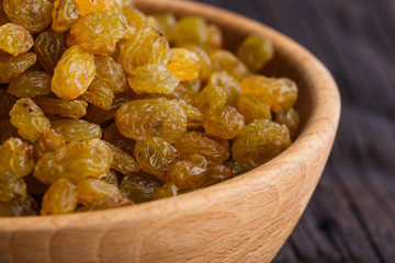 golden raisins on a wooden rustic background