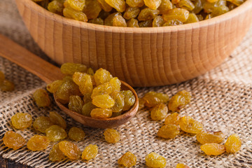 golden raisins on a wooden rustic background