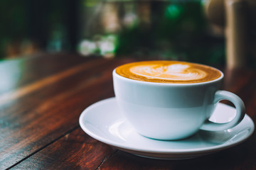 People are drinking a latte in a coffee shop.