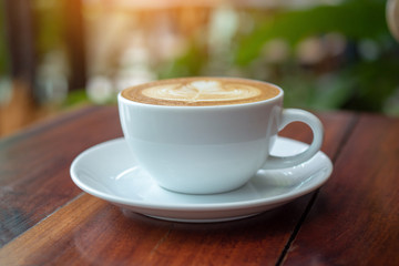 People are drinking a latte in a coffee shop.