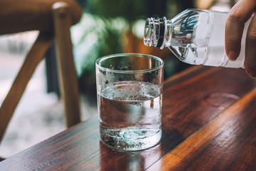 People pouring water into the glass