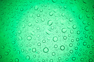 Rain droplets on green glass background, Water drops on glass.