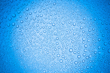 Rain droplets on blue glass background, Water drops on glass.