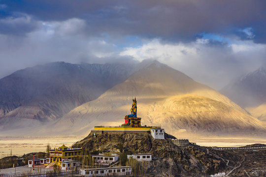 The Maitreya Buddha statue with Himalaya mountains in the background from Diskit Monastery or Diskit Gompa, Nubra valley, Leh Ladakh, Northen India.