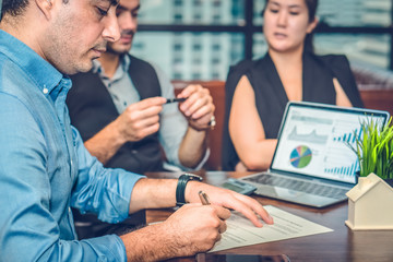 businessman signing contract on table