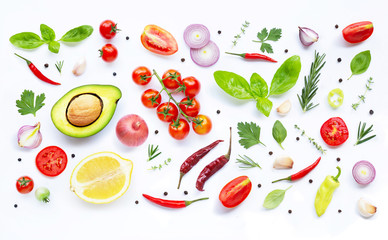 Various fresh vegetables and herbs on white background.