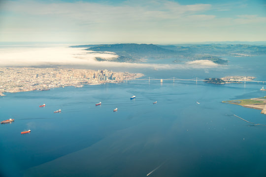 Aerial View of Downtown San Francisco With The Golden Gate Bridge Under Dense Clouds