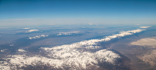 Panoramic View of Large Mountain Formation with Sunny Skies and Snow in the Peaks