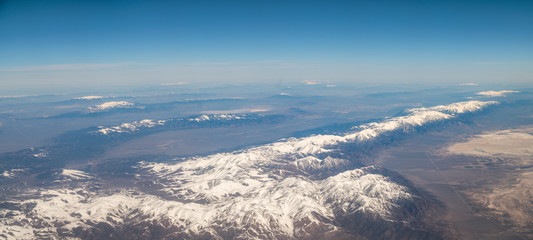 Fototapeta premium Panoramic View of Large Mountain Formation with Sunny Skies and Snow in the Peaks