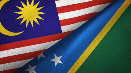 Malaysia and Solomon Islands two flags textile cloth, fabric texture