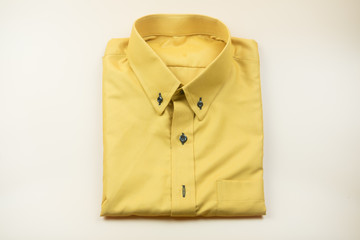 Men's yellow shirts Folded on a yellow background