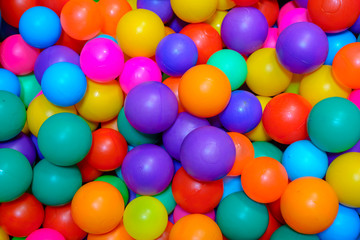 Fototapeta na wymiar Many colorful plastic balls in pool of game room. indoors playground