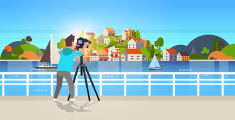 man travel photographer taking nature picture of mountain city island guy using dslr camera on tripod landscape background horizontal
