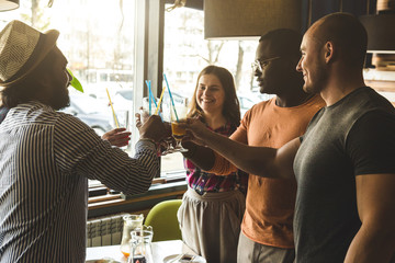 Meet young attractive people in the cafe. Friends chat, have fun, drink cocktails and eat
