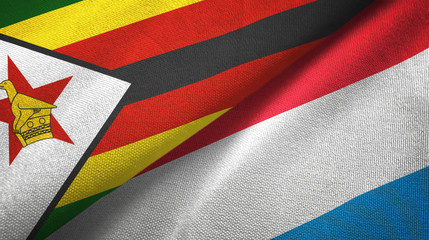 Zimbabwe and Luxembourg two flags textile cloth, fabric texture