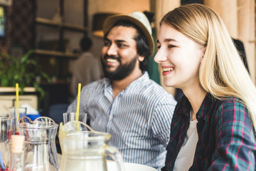 Meet young attractive people in the cafe. Friends chat, have fun, drink cocktails and eat