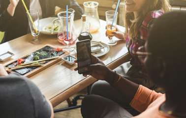 Meet young attractive people in the cafe. Friends chat, have fun, drink cocktails and eat