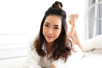 Portrait of asia woman enjoy and relax on the bed in bedroom at home.asian beauty