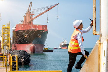 port control, harbour master, engineering or worker in duty of working in charge climbing to the station takes control ship loading in port, working in high at high level of risk and insurrance