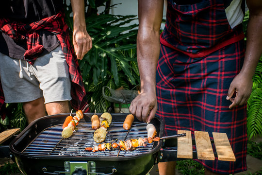 Happy friends with barbecue party in nature