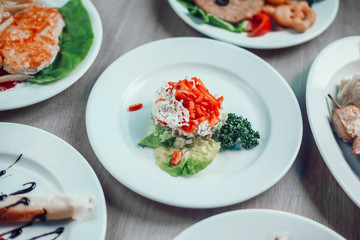kebab on a wooden skewer and other dishes for a family dinner in the restaurant