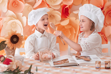 brother and sister in a chef uniform standing near the kitchen table